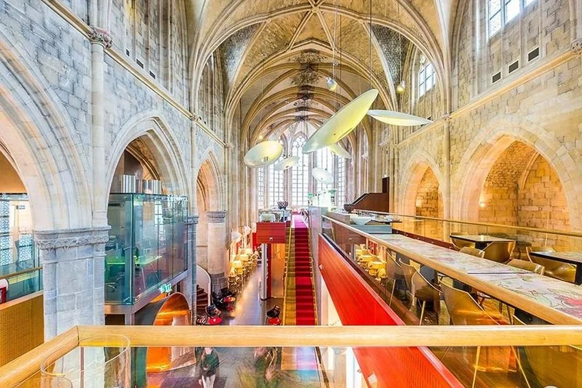 Gothic nave of Kruisherenhotel with a red carpet aisle in Maastricht, Netherlands