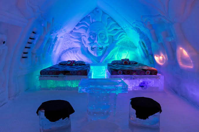 Ice suite with a carved face and two beds at Hotel de Glace near Quebec City, Canada