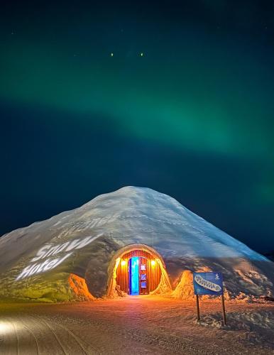 Snow Hotel entrance under the northern lights near Kirkenes, Norway